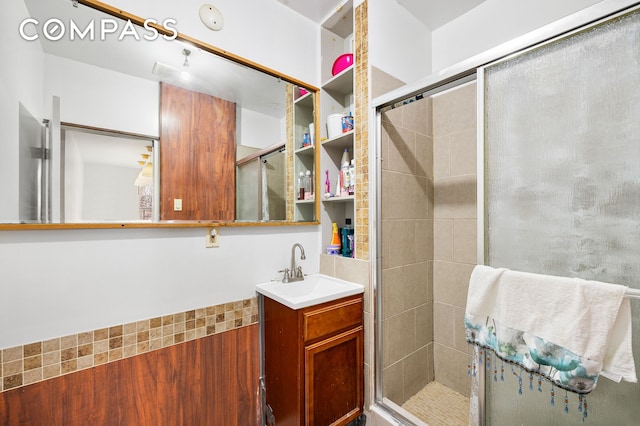 bathroom featuring a shower stall and vanity