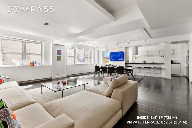 living room featuring track lighting, visible vents, and wood finished floors