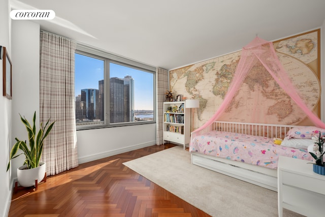 bedroom featuring a view of city, visible vents, and baseboards