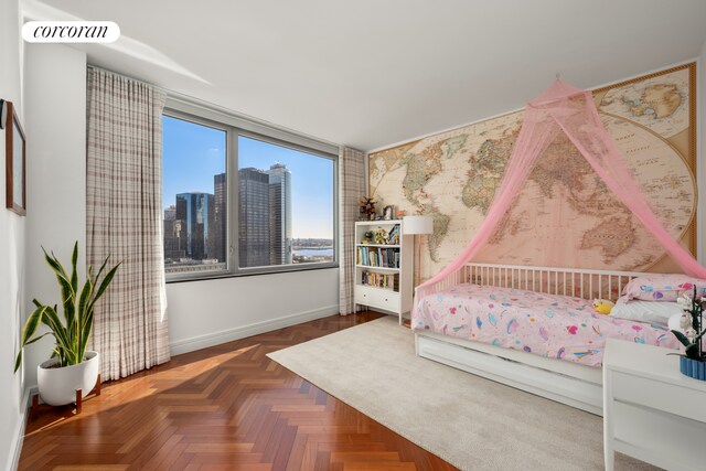 10 Little W St Unit 22E, New York City, NY 10004 - bedroom featuring a skyline view and baseboards