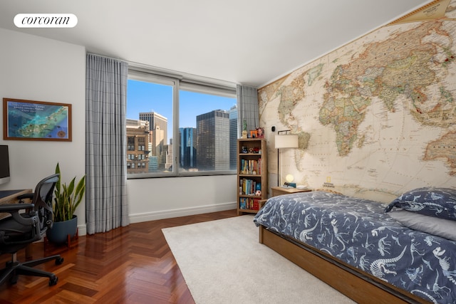 bedroom with visible vents, baseboards, wallpapered walls, and a city view