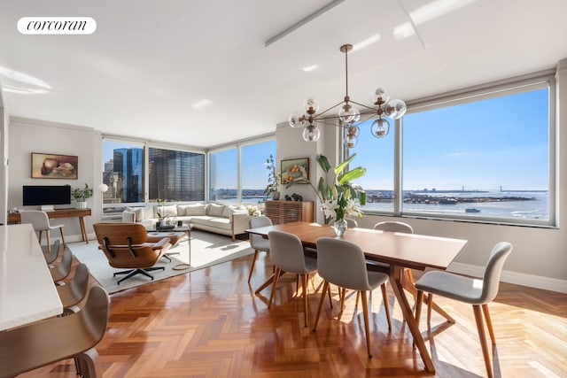 dining area with baseboards, visible vents, and a chandelier