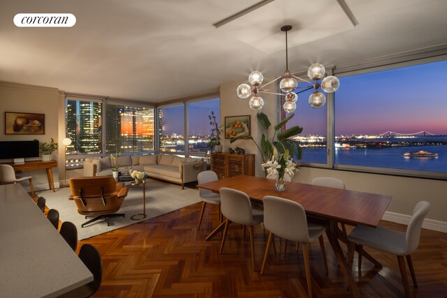 10 Little W St Unit 22E, New York City, NY 10004 - dining area with a chandelier, baseboards, and a water view