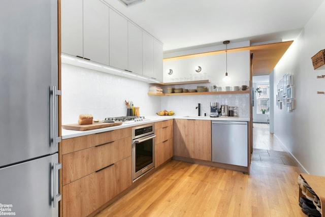 kitchen with open shelves, stainless steel appliances, light countertops, modern cabinets, and backsplash