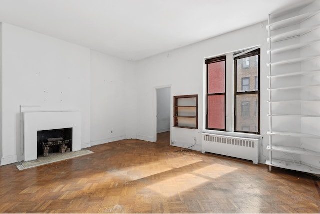 346 W 87th St, New York City, NY 10024 - unfurnished living room with radiator and a fireplace with flush hearth