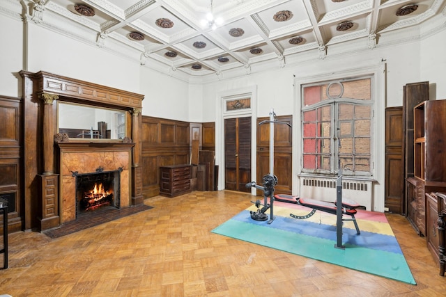 346 W 87th St, New York City, NY 10024 - exercise room featuring radiator heating unit, coffered ceiling, a fireplace with flush hearth, wainscoting, and ornamental molding