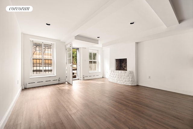unfurnished living room featuring a baseboard radiator, wood finished floors, and a fireplace
