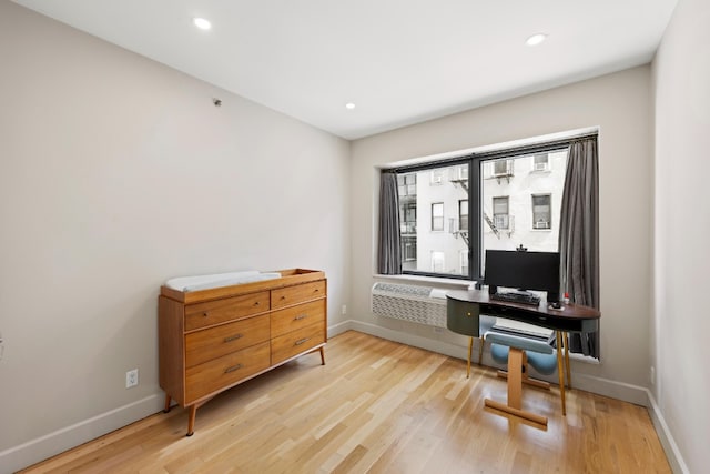 home office featuring recessed lighting, an AC wall unit, light wood-type flooring, and baseboards