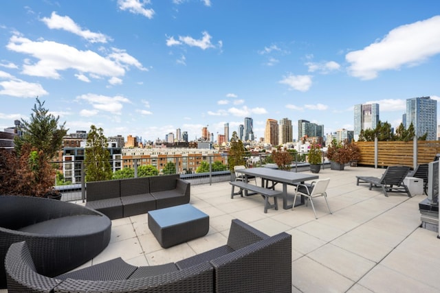 view of patio / terrace featuring a view of skyline, an outdoor living space, and outdoor dining area