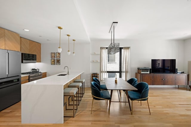 dining space featuring recessed lighting and light wood finished floors