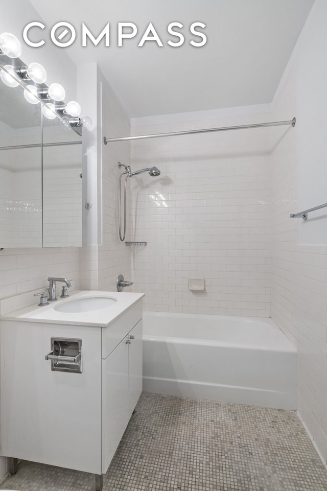 99 John St Unit 1711, New York City, NY 10038 - bathroom featuring vanity, bathtub / shower combination, tile patterned flooring, and tile walls