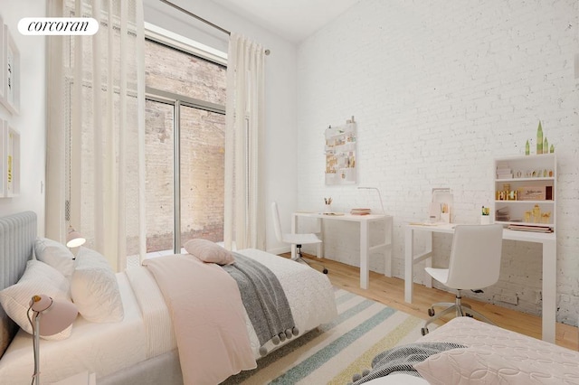 bedroom featuring multiple windows, brick wall, and wood finished floors