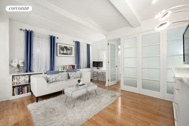 living room featuring visible vents, beam ceiling, wood finished floors, and french doors