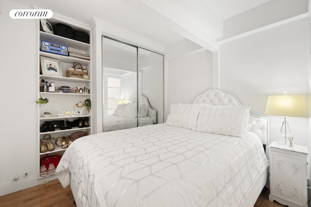 bedroom featuring a closet and wood finished floors