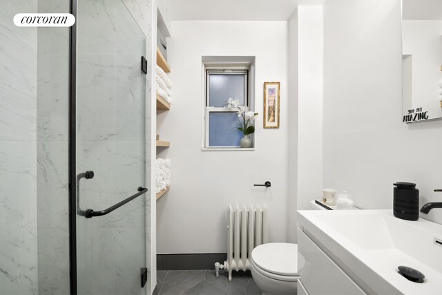 full bath with toilet, marble finish floor, radiator heating unit, a marble finish shower, and vanity