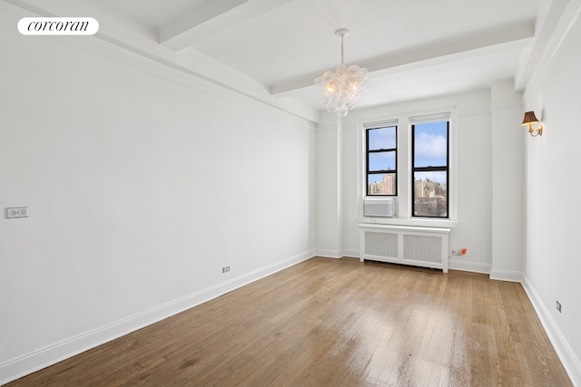 empty room featuring beamed ceiling, visible vents, a notable chandelier, hardwood / wood-style floors, and radiator