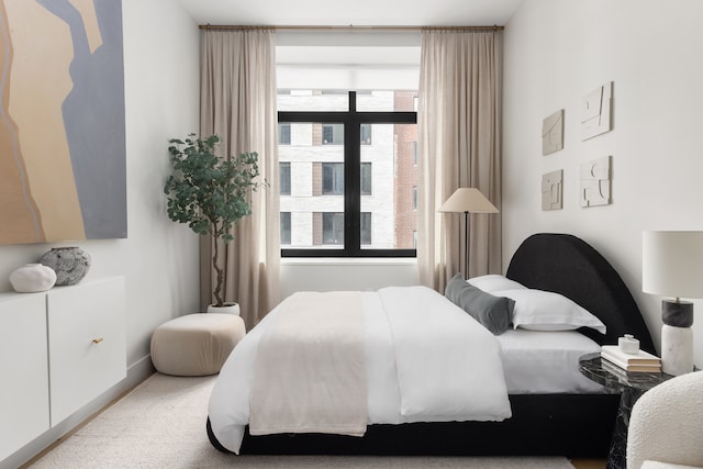 bedroom with baseboards, multiple windows, and carpet