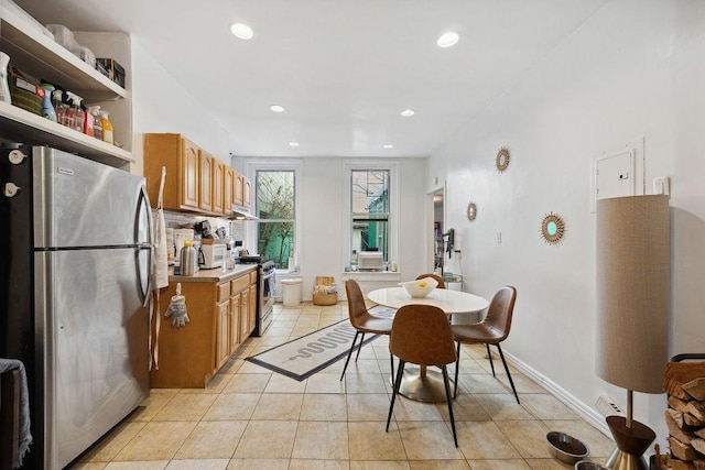 dining space with light tile patterned flooring, recessed lighting, and baseboards