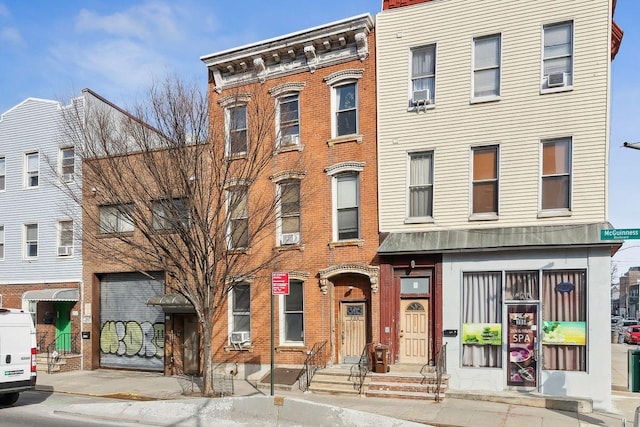 townhome / multi-family property featuring brick siding