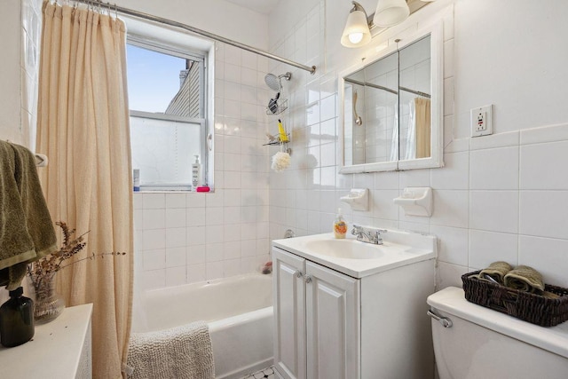 bathroom with toilet, tile walls, shower / bath combo, and vanity