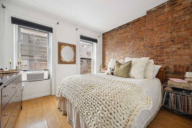 288 Mc Guinness Blvd Unit 1, 2, 3, New York City, NY 11222 - bedroom with brick wall, light wood-style flooring, baseboards, and cooling unit