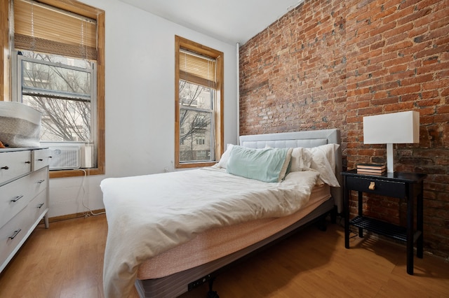 288 Mc Guinness Blvd Unit 1, 2, 3, New York City, NY 11222 - bedroom featuring light wood-style floors, brick wall, cooling unit, and baseboards