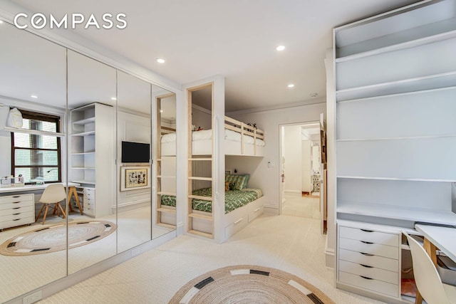bedroom featuring light colored carpet, built in study area, ornamental molding, and recessed lighting