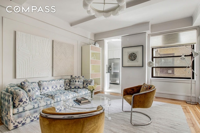 living area featuring beam ceiling, light wood-style floors, and ornamental molding