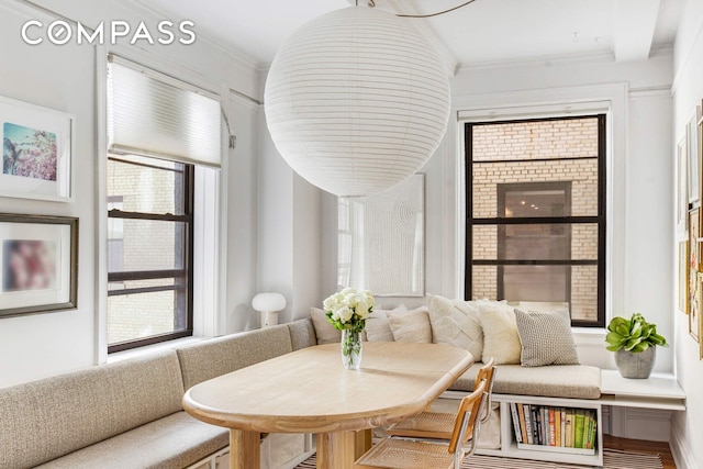 interior space with crown molding, breakfast area, and a wealth of natural light