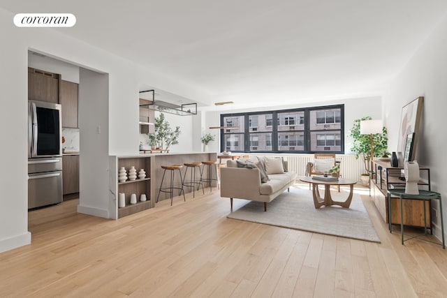 living room featuring visible vents and light wood-style flooring