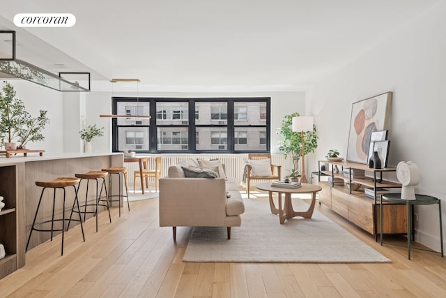 living area featuring visible vents and light wood-style flooring