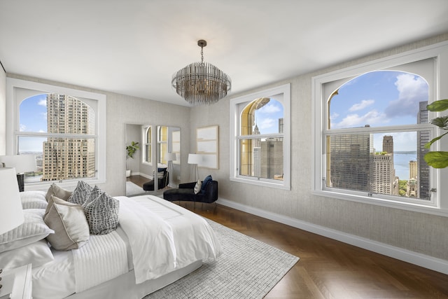 bedroom with a notable chandelier, multiple windows, wallpapered walls, and baseboards