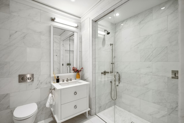 bathroom with vanity, tile walls, toilet, and a stall shower