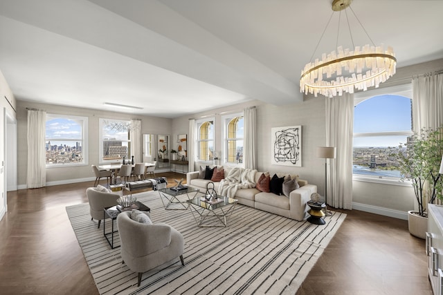 living room featuring baseboards and an inviting chandelier