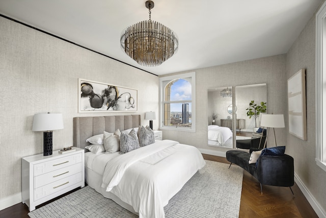 bedroom featuring a notable chandelier, wallpapered walls, and baseboards