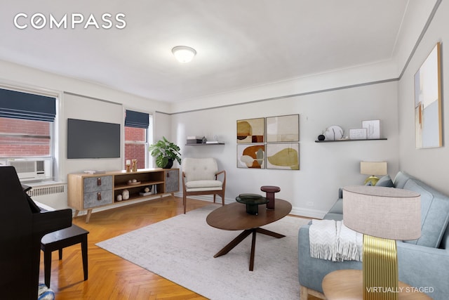 living room featuring cooling unit, baseboards, and radiator