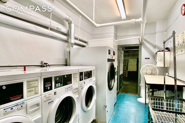community laundry room featuring stacked washer / dryer and washer and clothes dryer