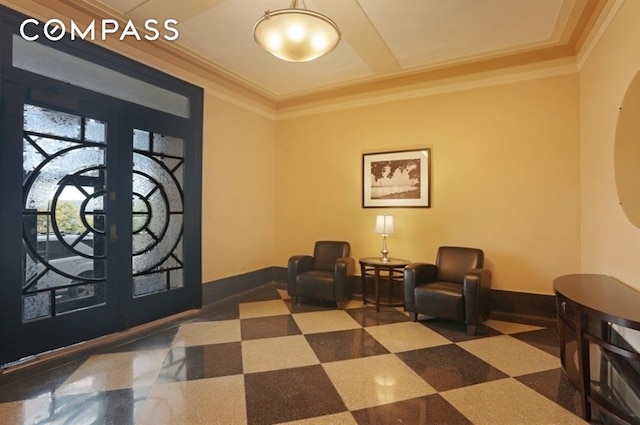 foyer with arched walkways, french doors, baseboards, and ornamental molding