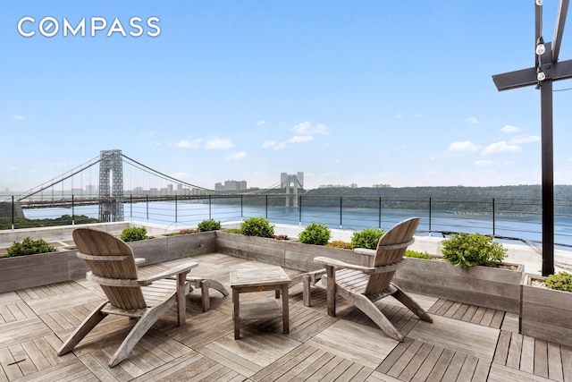 wooden deck featuring a water view