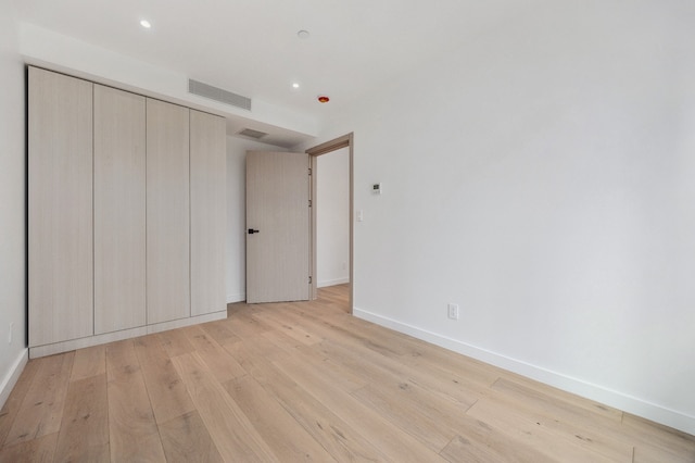 unfurnished bedroom featuring recessed lighting, light wood-style floors, visible vents, and baseboards