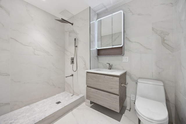 bathroom featuring a marble finish shower, toilet, marble finish floor, and vanity