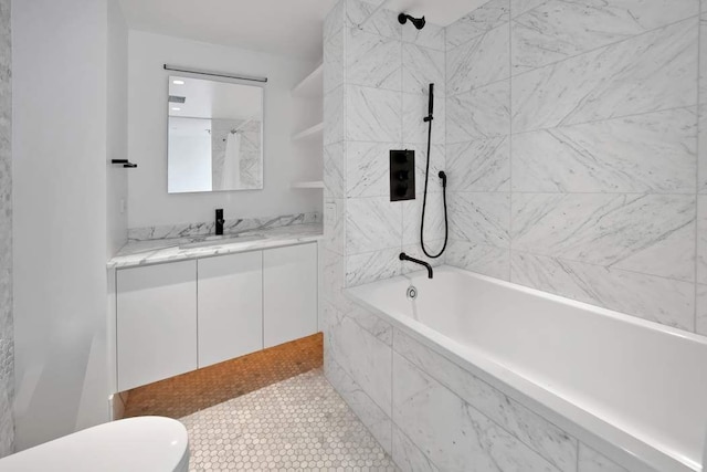 full bathroom featuring tiled shower / bath and vanity