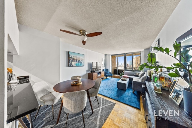 dining room featuring ceiling fan and a textured ceiling