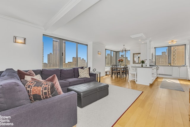 living room with a view of city, crown molding, and light wood finished floors