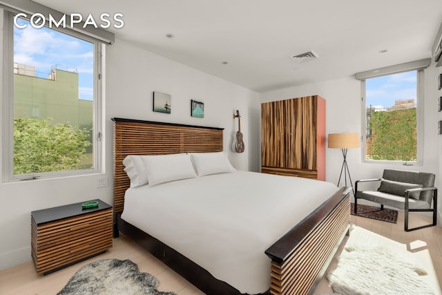 bedroom featuring visible vents and light wood-type flooring