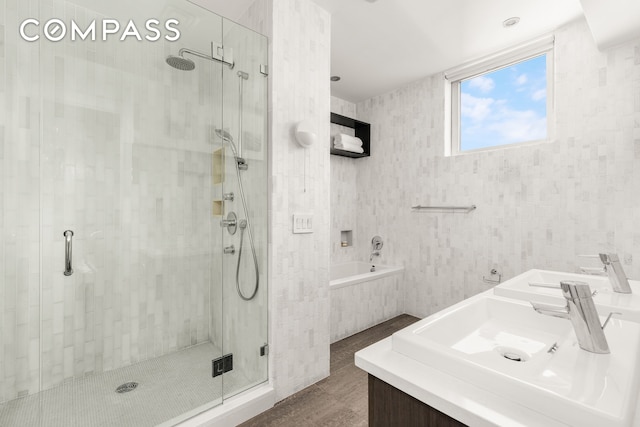 full bath with tile patterned flooring, a stall shower, a bath, and vanity