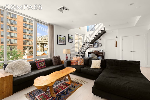 living room with visible vents and stairs