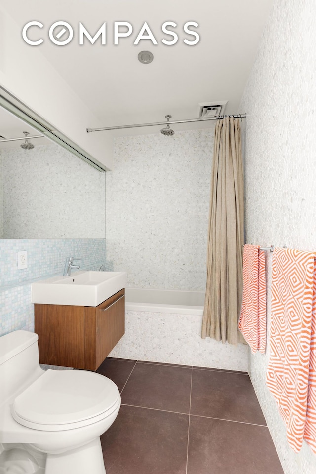 full bath with vanity, visible vents, tiled shower / bath combo, tile patterned floors, and toilet