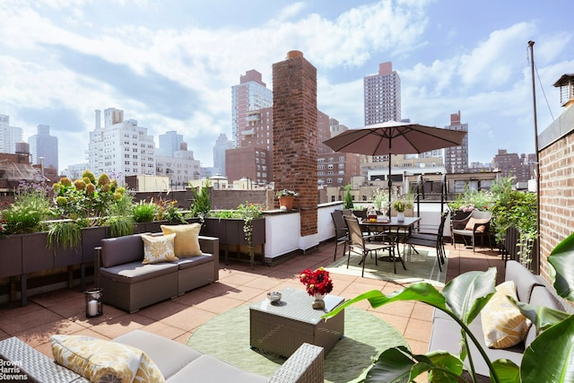 view of patio / terrace with a city view and an outdoor living space