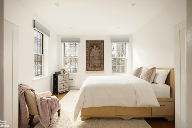 338 E 78th St Unit 5R, New York City, NY 10075 - bedroom with wood finished floors, a wall unit AC, and baseboards